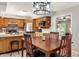 A dining room showcases a wood table and chairs, leading to the kitchen with wood cabinets at 453 N 275 E, Columbus, IN 47203