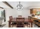 The dining room features a dark wood table set with four chairs and a modern light fixture at 453 N 275 E, Columbus, IN 47203