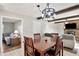 Cozy dining room with rustic table, stylish light fixture, and view into the living room, creating a warm atmosphere at 453 N 275 E, Columbus, IN 47203