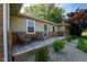 Inviting front porch with two chairs and small table, complemented by decorative stone landscaping and mature bushes at 453 N 275 E, Columbus, IN 47203