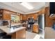 The kitchen is well-lit with oak cabinets, stainless steel appliances, and a mosaic tile backsplash at 453 N 275 E, Columbus, IN 47203