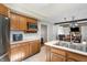 The kitchen features a double basin sink, stainless steel appliances, and wood cabinets at 453 N 275 E, Columbus, IN 47203