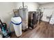 Functional laundry room featuring a washer, dryer, water heater, and water softener system at 453 N 275 E, Columbus, IN 47203