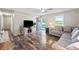 Open-concept living room with fireplace, hardwood floors, modern furniture and a view to the front entrance at 453 N 275 E, Columbus, IN 47203