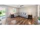 Inviting living room with a large sectional sofa, stylish end tables, and a view to the front yard at 453 N 275 E, Columbus, IN 47203