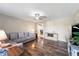 Comfortable living room featuring a large sectional sofa, wood-style flooring, and a cozy atmosphere at 453 N 275 E, Columbus, IN 47203
