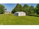 Spacious outbuilding with a lean-to on a lush green lot, perfect for storage or hobbies at 453 N 275 E, Columbus, IN 47203