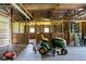 Outbuilding interior including lawn equipment and wooden horse stalls at 453 N 275 E, Columbus, IN 47203