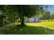 Outbuilding with a hammock hanging in the shade of a tree, creating a peaceful outdoor space at 453 N 275 E, Columbus, IN 47203
