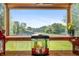 A decorative fish tank sits in front of a window overlooking a lush, green yard at 453 N 275 E, Columbus, IN 47203