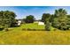 Picturesque lot with mature trees, an outbuilding, and fenced areas offering privacy and plenty of space at 453 N 275 E, Columbus, IN 47203