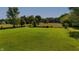 Expansive green lot with a fence and treed perimeter, ready for your dream home or outdoor activities at 453 N 275 E, Columbus, IN 47203