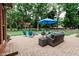 Inviting backyard patio with comfortable seating and a bright blue umbrella for outdoor enjoyment at 46 Hawthorne Ct, Carmel, IN 46033