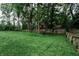 Large backyard with a wooden fence, mature trees, and plenty of green space for recreation and enjoyment at 46 Hawthorne Ct, Carmel, IN 46033