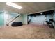 Finished basement with stairway, blue walls, drop ceiling, and dedicated gaming/work space at 46 Hawthorne Ct, Carmel, IN 46033