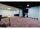 Finished basement with blue walls, drop ceiling, gaming setup, and comfortable seating at 46 Hawthorne Ct, Carmel, IN 46033
