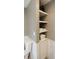 Clean bathroom features a toilet with tiled surround and built-in shelving for organized storage at 46 Hawthorne Ct, Carmel, IN 46033
