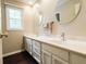 Bathroom showcases double vanity, modern faucets, wood floors, natural light, and coordinating round mirrors at 46 Hawthorne Ct, Carmel, IN 46033