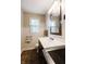 Bathroom with white vanity, dark wood cabinets, and framed mirror at 46 Hawthorne Ct, Carmel, IN 46033