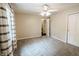 Neutral bedroom features a ceiling fan, grey carpeting, and a door for closet or bathroom access at 46 Hawthorne Ct, Carmel, IN 46033