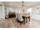 The dining area boasts hardwood floors, tufted chairs, and an upright piano, ideal for Gathering gatherings at 46 Hawthorne Ct, Carmel, IN 46033