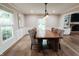 A dining room is bathed in natural light, featuring wainscoting and a charming view of the fireplace at 46 Hawthorne Ct, Carmel, IN 46033
