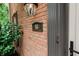 A close-up reveals the front door, accented by a classic address plaque and decorative outdoor lighting at 46 Hawthorne Ct, Carmel, IN 46033