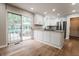 Bright kitchen with white cabinets, granite countertops, and access to outdoor patio at 46 Hawthorne Ct, Carmel, IN 46033