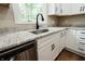 Close-up of the kitchen sink with granite countertops and stainless steel appliances at 46 Hawthorne Ct, Carmel, IN 46033