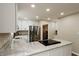 Modern kitchen with white cabinets, stainless steel appliances, and granite countertops at 46 Hawthorne Ct, Carmel, IN 46033
