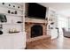 Cozy living room with brick fireplace, built-in shelves, and hardwood flooring for relaxing evenings at 46 Hawthorne Ct, Carmel, IN 46033