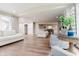 Spacious living room with hardwood floors and neutral tones, connected to a dining area for easy entertaining at 46 Hawthorne Ct, Carmel, IN 46033