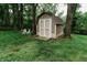 Charming storage shed with double doors, nestled among trees, with a small seating area nearby at 46 Hawthorne Ct, Carmel, IN 46033