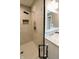Walk-in shower with marble tile, glass door, and rainfall showerhead at 46 Hawthorne Ct, Carmel, IN 46033