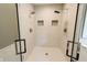 Tiled shower featuring a glass enclosure, dual shower heads and tiled nooks at 46 Hawthorne Ct, Carmel, IN 46033