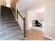 Carpeted staircase with wooden railing, leading to upper level; view to the living room at 46 Hawthorne Ct, Carmel, IN 46033