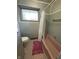 Bathroom featuring a pink tub and traditional tile work at 4609 Andover Rd, Indianapolis, IN 46226