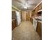 Functional kitchen with wood cabinets, white appliances, and ample counter space at 4609 Andover Rd, Indianapolis, IN 46226