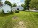 Well-maintained backyard with a healthy lawn, minimal landscaping, and a white picket fence at 472 N 17Th St, Noblesville, IN 46060
