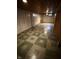 A largely unfinished basement space with wood-look paneling, tile floors, and recessed lighting at 472 N 17Th St, Noblesville, IN 46060
