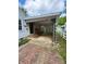 Carport and covered parking area with brick pathway and decorative iron supports at 472 N 17Th St, Noblesville, IN 46060