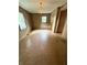 Empty living room with wood-look paneling, vintage linoleum floors, and stained-glass-look light fixture at 472 N 17Th St, Noblesville, IN 46060