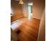 Empty living room with wood-look paneling, hardwood floors, and stained-glass-look light fixture at 472 N 17Th St, Noblesville, IN 46060