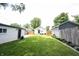 The backyard offers a spacious lawn, ideal for outdoor activities, framed by the home's exteriors at 4927 Caroline Ave, Indianapolis, IN 46205