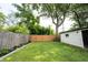 The backyard has a well-manicured lawn, with a wood fence adding privacy to the outdoor space at 4927 Caroline Ave, Indianapolis, IN 46205