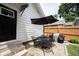 Backyard showcasing a patio area, table set, grill and a lush lawn surrounded by trees and fencing at 4927 Caroline Ave, Indianapolis, IN 46205
