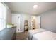 Well-lit bedroom showing a bed, dresser, and mirror with two doors offering views into the house at 4927 Caroline Ave, Indianapolis, IN 46205