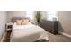 Cozy bedroom showcasing a well-made bed with stylish pillows, blanket, side tables and large dresser at 4927 Caroline Ave, Indianapolis, IN 46205