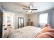 Bedroom with natural light, soft linens, ceiling fan and wood look flooring at 4927 Caroline Ave, Indianapolis, IN 46205