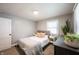 Bright bedroom featuring a well-made bed with stylish pillows, side tables and large dresser at 4927 Caroline Ave, Indianapolis, IN 46205